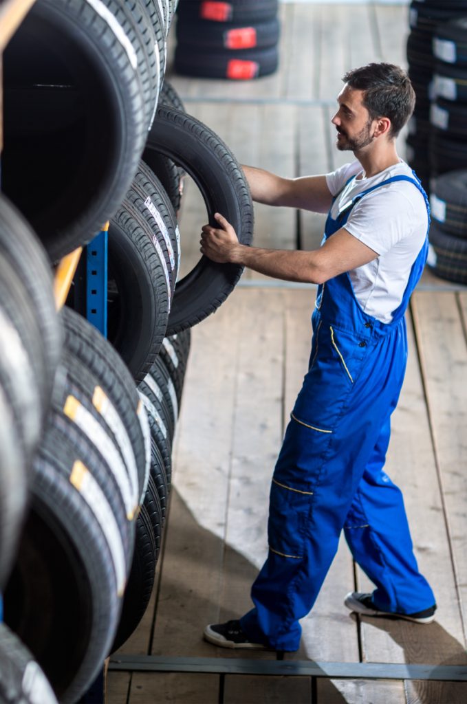 Mechanic taking out a tyre from stock - Tyres Fareham